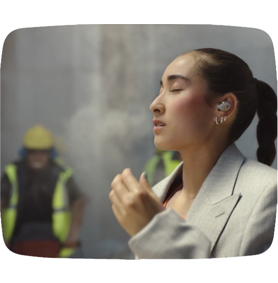 Woman wearing JBL Tour Pro 3 with True Adaptive Noise Cancellation